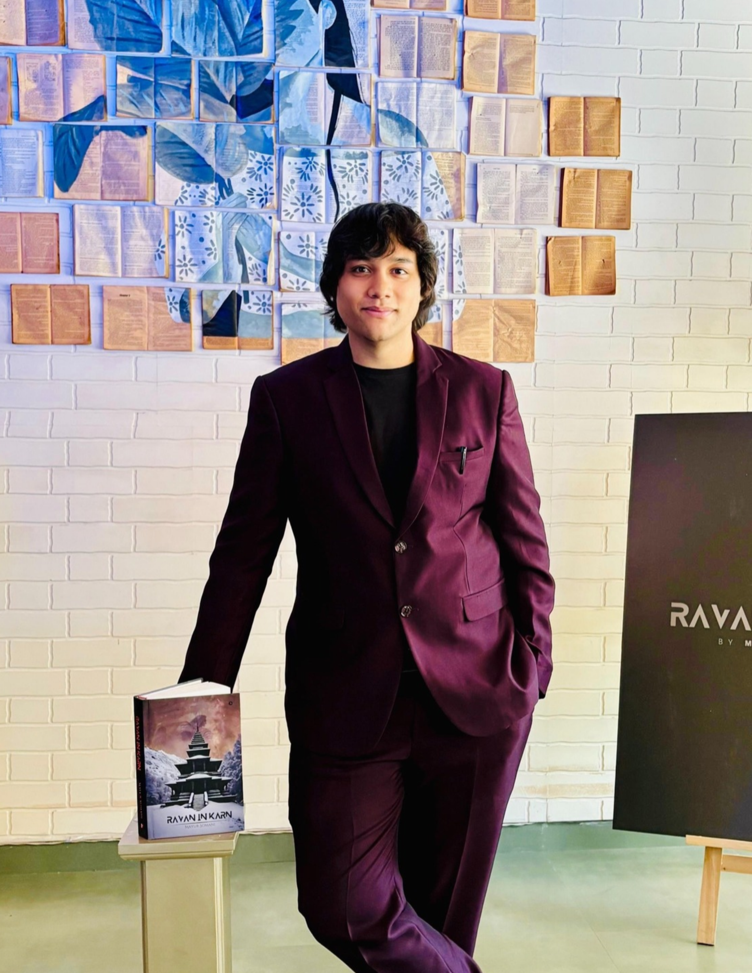 Mayur Somani, entrepreneur and author, standing beside his book Ravan in Karn